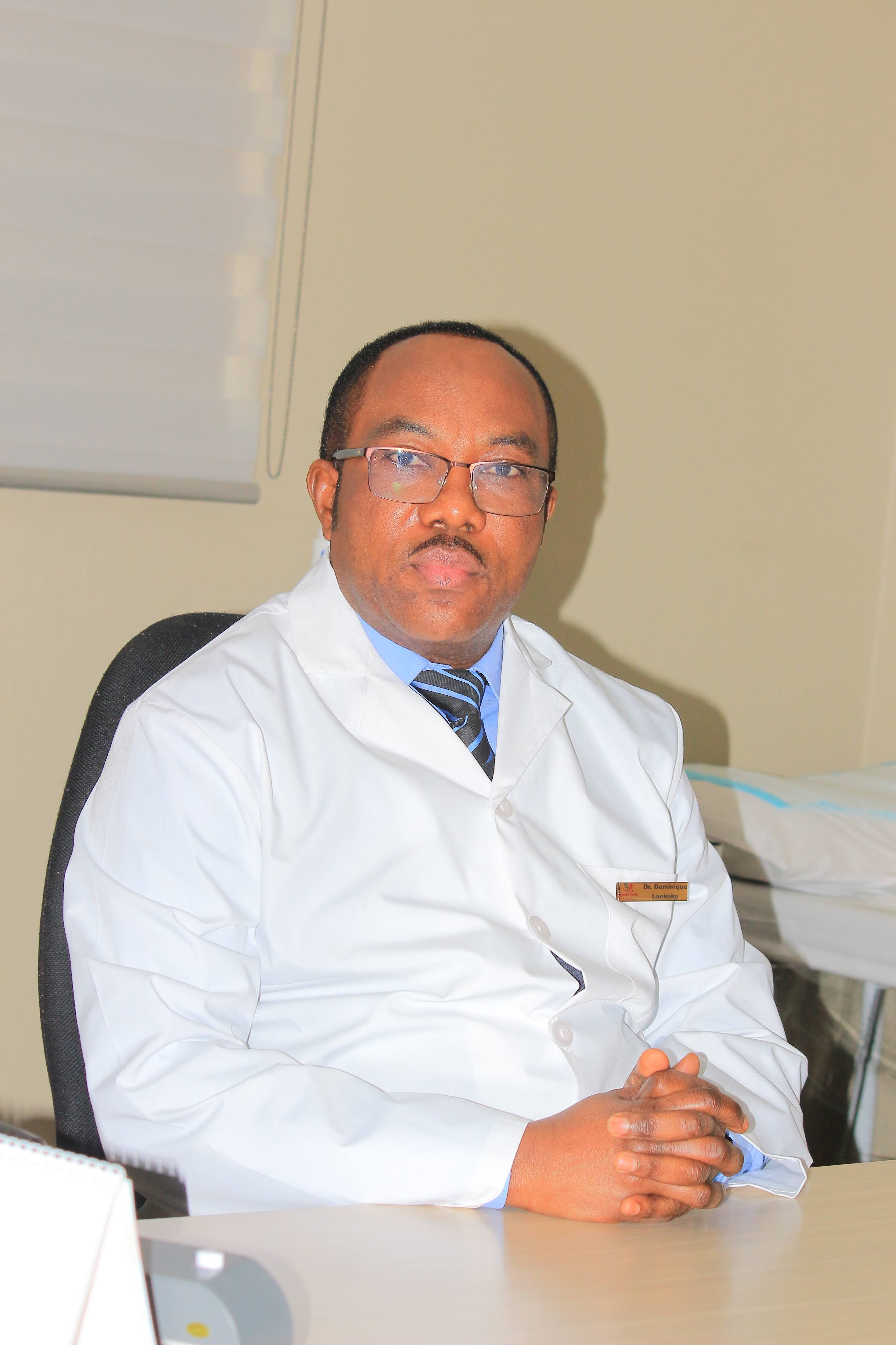 Dr. Ntobe Dominique Lankoko seated in consultation room