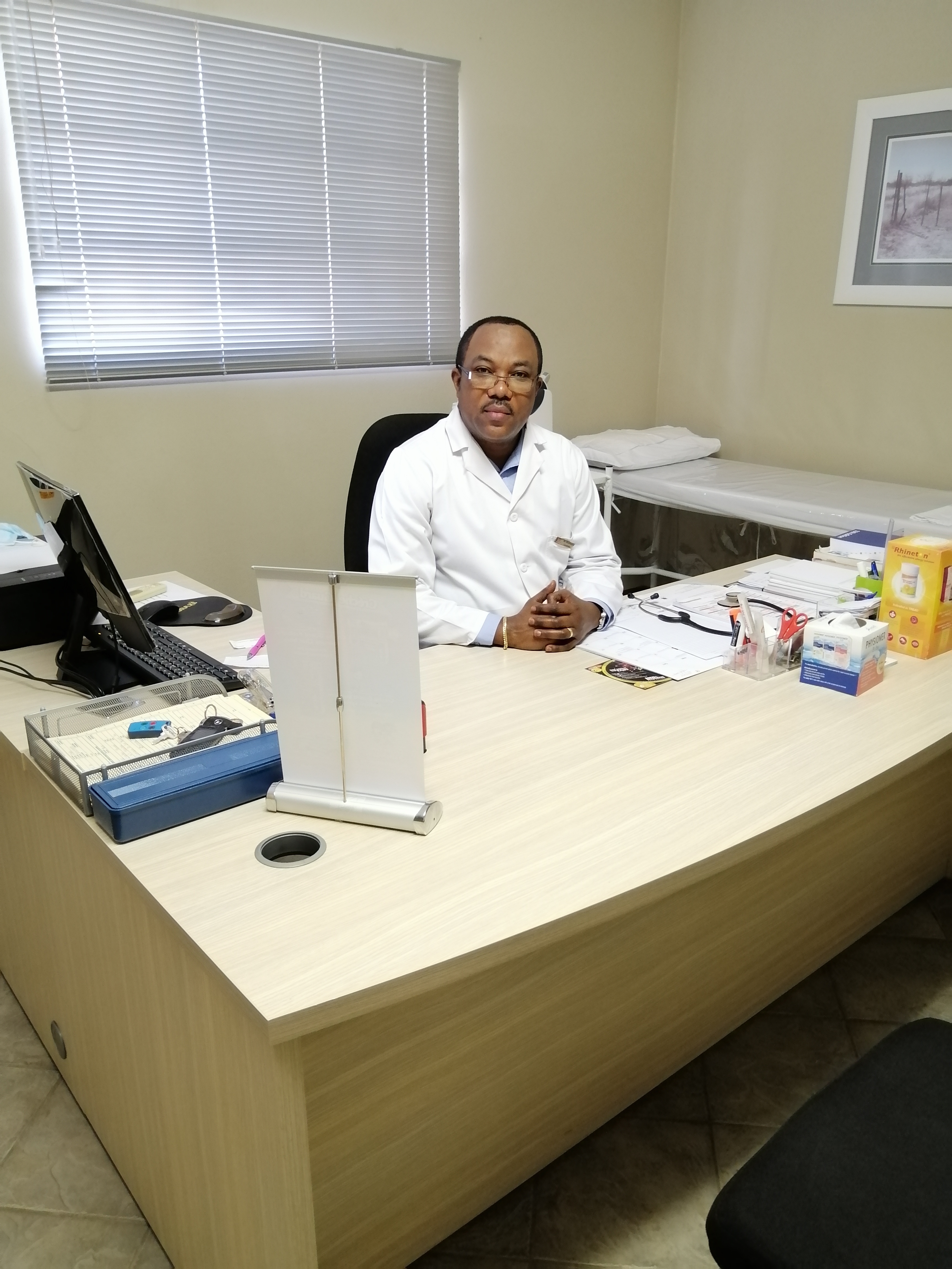 Dr. Lankoko seated behind his desk